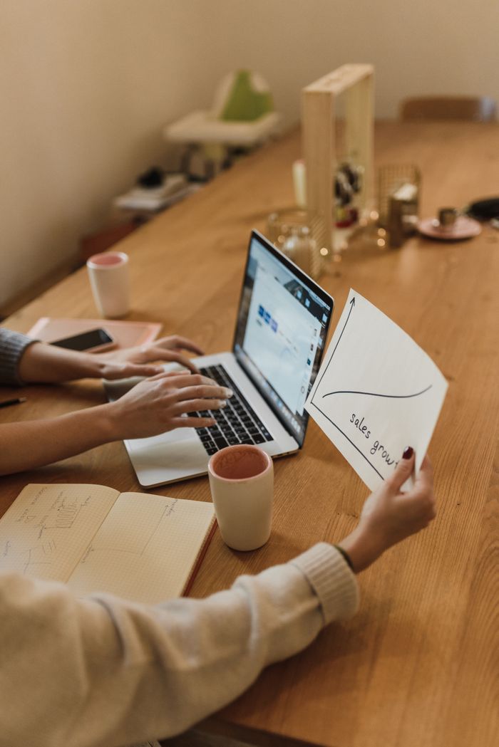 Scaling Your Business with Digital Advertising Team analyzing sales growth chart during a collaborative office meeting.