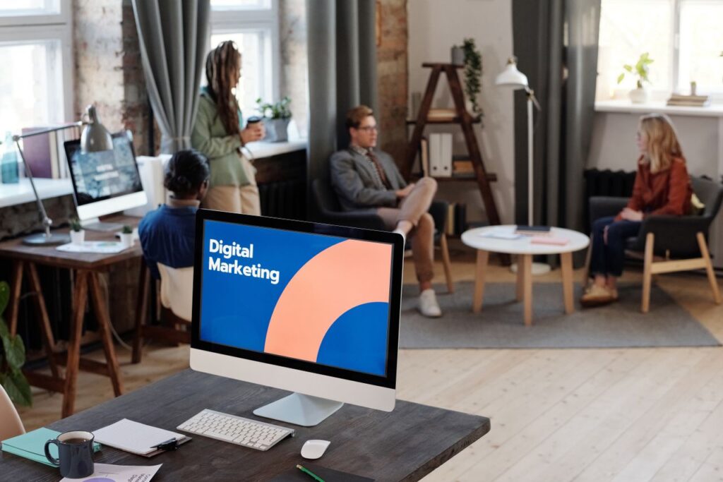 Hello world! Collaborative team meeting in a modern office setting with digital marketing focus.